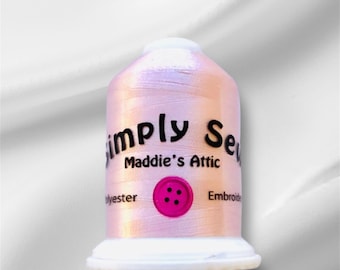 May include: A spool of iridescent pink polyester embroidery thread with the text "Simply Sew Maddie's Attic" and a pink button with four holes.