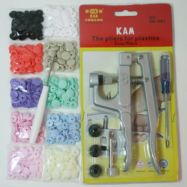 May include: A set of plastic snap fasteners in various colors, including black, white, pink, light blue, lavender, and green. The set also includes a tool for attaching the snaps, a screwdriver, and a needle.