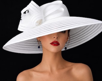 May include: A wide-brimmed white hat featuring a structured crown and a large, layered decorative bow detail on the side. The hat is crafted from a textured material with horizontal ribbed lines throughout the brim and crown, creating a formal look.