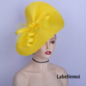 May include: A bright yellow hat with a large, floppy brim and a bow made of the same fabric. The hat is made of a straw-like material and has a delicate, feminine feel.
