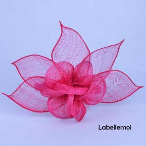 May include: A bright pink flower made of mesh fabric. The flower has a layered design and is perfect for adding a touch of color to any outfit.
