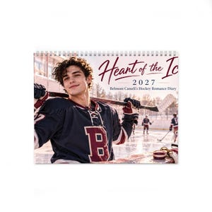 May include: A 2027 spiral-bound calendar titled Heart of the Ice: Belmont Cameli's Hockey Romance Diary, featuring a photograph of a hockey player in a dark blue and maroon jersey holding a hockey stick on an outdoor ice rink.