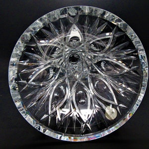 Puede incluir: Un cuenco de cristal transparente con un patr&oacute;n decorativo en forma de estrella en el fondo. El cuenco es redondo y tiene una superficie lisa y pulida.