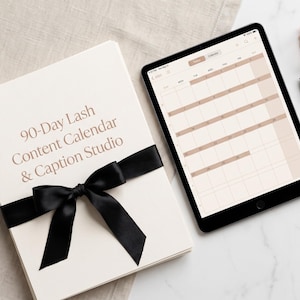 May include: A stack of white paper with the text 90-Day Lash Content Calendar & Caption Studio tied with a black ribbon, next to a tablet displaying a monthly calendar grid, a rose gold eyelash curler, and a small black mascara spoolie brush.