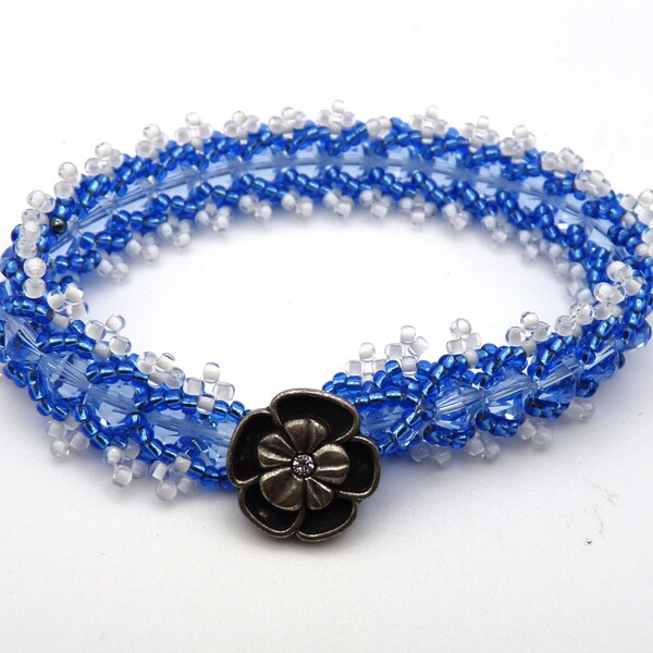 Blue crystal bicone beaded bracelet with lustrous blue and white lined clear Japanese seed beads - flower button closure