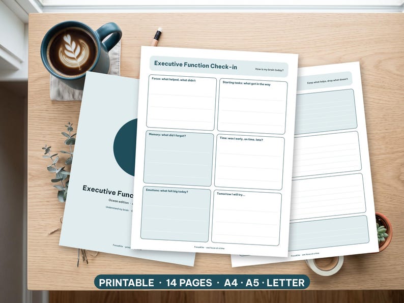 Minimalist executive function worksheets printed and resting on a bright wooden desk with a pen.
