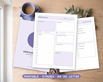 May include: A set of lavender-themed daily planner pages featuring a Daily Focus sheet with time blocks, a brain dump section, and energy trackers. The printable documents include sections for quick wins, kindness to myself, and notes in a clean layout.