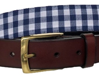 May include: A brown leather belt with a gold buckle and a blue and white gingham pattern on the strap.