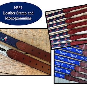 May include: A collection of leather belts with various embroidered designs, including a lobster, lacrosse sticks, and a whale. The belts are brown leather with a dark brown buckle. The text "N°27 Leather Stamp and Monogramming" is visible in the image.