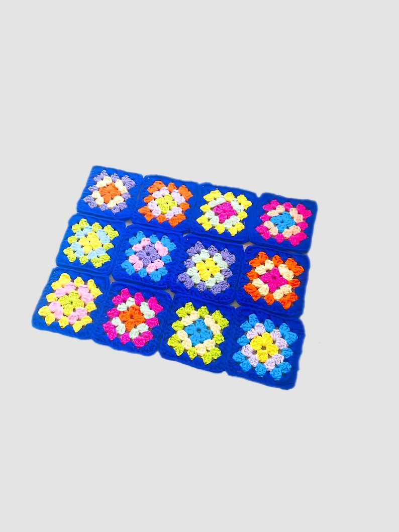May include: A blue crocheted blanket with colorful squares. Each square has a different pattern of pink, yellow, orange, blue, and green.