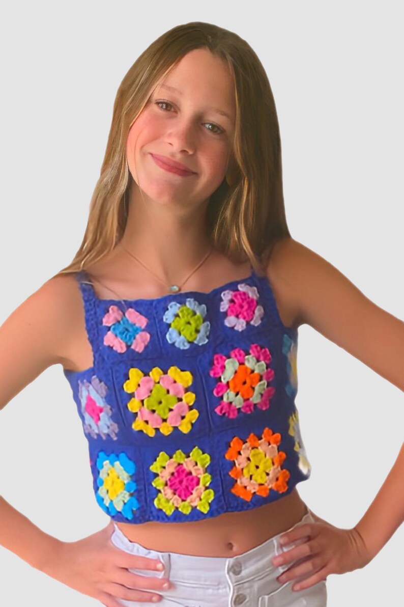 May include: A blue crochet top with colorful squares. The top is sleeveless and has a square neckline. The squares are made in a variety of colors, including pink, yellow, green, orange, and blue.