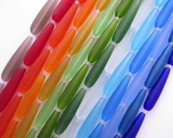 Cuentas de vidrio marino cultivado en forma de lágrima: colores variados opacos, transparentes y esmerilados, cuentas perforadas de 38 x 9 mm de largo.