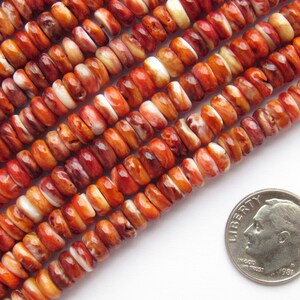 Peut inclure: Rang&eacute;es de perles en coquillage d'hu&icirc;tre &eacute;pineuse, aux tons orange, rouge et blanc. Les perles sont petites, plates et de forme irr&eacute;guli&egrave;re. Une pi&egrave;ce de 10 cents am&eacute;ricaine est incluse pour la r&eacute;f&eacute;rence de taille. Ces perles conviennent &agrave; la fabrication de bijoux.