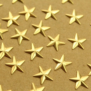 May include: A close-up of a brown surface covered with gold-colored five-pointed stars.