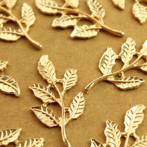 May include: Gold leaf-shaped metal embellishments with a delicate, intricate design. These decorative pieces are perfect for adding a touch of elegance to crafts, jewelry, and other projects.