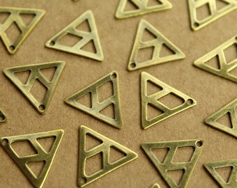 May include: A collection of gold-toned metal triangle charms with a geometric pattern. The charms have a hole at the top for attaching to jewelry or other crafts.