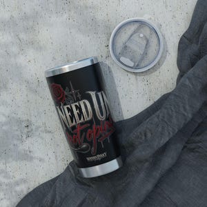 May include: A black stainless steel tumbler with a silver rim and base, featuring a red rose graphic and the text "NEED U" in white and "not opinions" in red. The tumbler includes a clear plastic lid with a sliding closure mechanism.