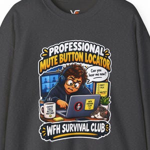 May include: A dark grey crewneck sweatshirt featuring a graphic of a person wearing headphones at a laptop with a cat, a coffee mug, and text that reads Professional Mute Button Locator and WFH Survival Club with Can you hear me now?