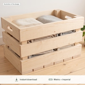 May include: A rectangular light-colored wooden crate with horizontal slats and cutout handles on the sides. The crate is filled with folded neutral-toned fabric items. A small label at the top left reads Illustration of the design.