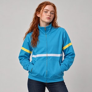 May include: A bright blue zip-up track jacket featuring a high collar, long sleeves with yellow horizontal stripes, and a wide white horizontal stripe across the chest. The jacket includes two front pockets and a full-length metal zipper.