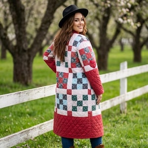 May include: A long, quilted coat featuring a patchwork pattern of squares in shades of red, light blue, and dark green, with solid red quilted sleeves and a solid red quilted hem. The coat is worn with blue jeans and brown leather cowboy boots.