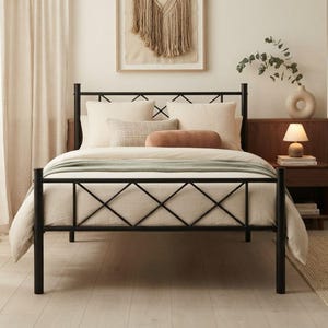 May include: A black metal bed frame featuring a headboard and footboard with a geometric diamond lattice pattern. The bed is dressed with cream-colored bedding, including two large square pillows, a rectangular accent pillow, and a throw.