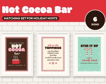 Könnte beinhalten: Ein Set aus sechs gerahmten Schildern für eine heiße Schokoladenbar. Die Schilder enthalten Texte wie Welcome to the Hot Cocoa Bar, Pile on the Toppings und Stir it up with a candy cane, mit Abbildungen einer roten Tasse und Zuckerstangen in Rot, Weiß und Braun.