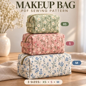 May include: Three rectangular quilted makeup bags stacked vertically. The top bag is sage green with white daisies, the middle is dusty pink with small flowers, and the bottom is cream with blue flowers. Text reads: MAKEUP BAG PDF SEWING PATTERN.
