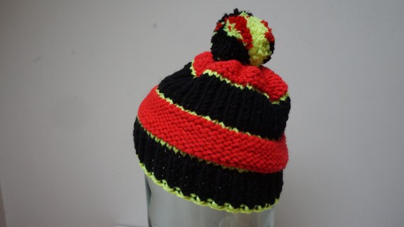 red and black bobble hat