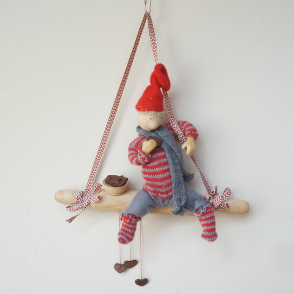Elf eating gingerbread cookies on roller pin scene, wall hanging Swedish gnome, Scandinavian red pixie tomte doll Christmas figurine Sweden