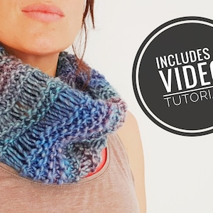 May include: A woman wearing a blue and purple knitted cowl neck scarf. The image includes the text "Includes a Video Tutorial".