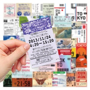 Japan ticket sticker held in front of assortment