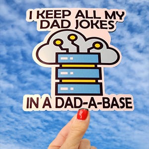 May include: A die-cut sticker featuring a light blue server rack icon topped with a grey cloud and yellow circuit nodes. The text reads I KEEP ALL MY DAD JOKES IN A DAD-A-BASE in bold black capital letters against a light pink background.