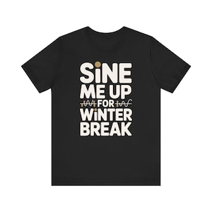 May include: A black short-sleeved t-shirt featuring the cream-coloured text "SINE ME UP FOR WINTER BREAK" with a small sine wave graphic integrated into the word "FOR". The design is centred on the chest of the garment in a bold, sans-serif font.