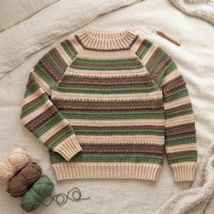 May include: A long-sleeve crochet sweater featuring horizontal stripes in shades of cream, sage green, and dark brown. The garment has a ribbed crew neckline, cuffs, and hem, with a textured bobble stitch pattern integrated into the striped design.