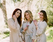 6 knee length robes in faux crepe de chine silk trimmed with lace. Bridal robes and bridesmaids robes in neutral tones.