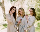 6 knee length robes in faux crepe de chine silk trimmed with lace. Bridal robes and bridesmaids robes in neutral tones.