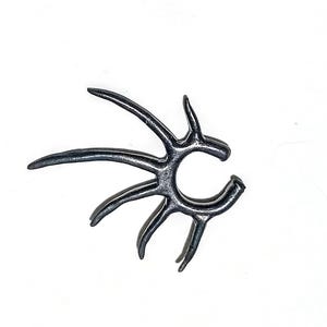 May include: A dark gray ear cuff with a unique, abstract design. The cuff features multiple curved and pointed elements radiating from a central point, creating a stylized, organic shape. The jewelry is set against a white background.