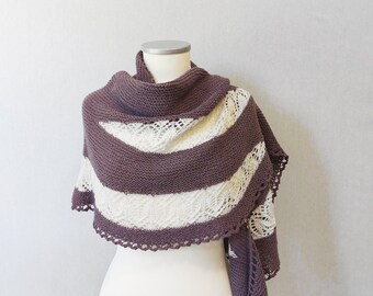 May include: A knitted shawl with a white and purple striped pattern. The shawl has a crocheted edge and is displayed on a white mannequin.