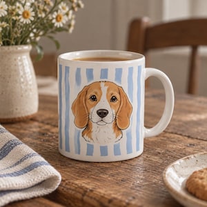 May include: A white ceramic mug featuring a central illustration of a brown and white beagle dog face. The background of the mug is decorated with vertical light blue stripes. The mug has a standard handle and a smooth, glossy finish.