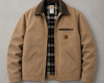 May include: A tan canvas jacket featuring a dark brown corduroy collar, a full-length front zip, and a black, white, and tan plaid flannel lining. The jacket includes two lower slanted pockets, a zipped chest pocket, and a Carhartt brand label.