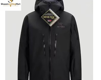 May include: A black hooded jacket featuring a full-length front zip, two large vertical chest pockets with zips, and a smaller zipped pocket on the left sleeve. The jacket displays an Arc'teryx logo and a Gore-Tex product hang tag.
