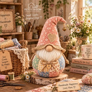 May include: A fabric gnome with a floral hat, a burlap heart patch, and a patchwork body in pastel colors. The gnome has a white beard, a wooden nose, and a small bell on the hat tip. It sits on a wooden slice, surrounded by sewing supplies.