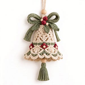 May include: A macrame bell ornament featuring cream-colored cord with intricate knotting, accented by sage green cord details, small wooden beads, and clusters of dark red berries. A sage green tassel hangs from the bottom of the bell.