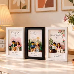 May include: Three rectangular shadow box frames containing custom minifigure displays. The left frame reads 'You & Me', the center 'Our Adventure', and the right 'Forever Together', each featuring personalized names, dates, and miniature figures.