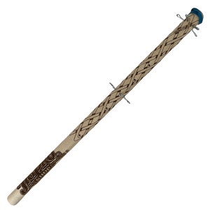 May include: A wooden stick with a blue and white cap on the top. The stick is decorated with a brown Celtic knot design and the words "Celtic Knot" are engraved on the stick. There are several metal pins sticking out of the stick.