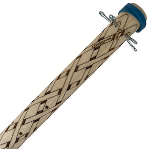 May include: A wooden dowel with a woven pattern and the words "Over" and "Under" engraved on it. The dowel has a blue rubber band and metal hooks at the top.