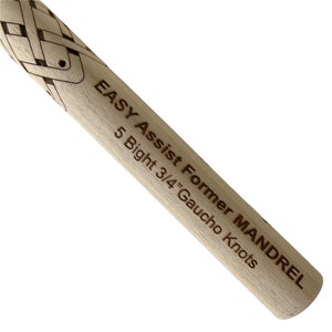 May include: Close-up of a wooden dowel with the text "EASY Assist Former MANDREL 5 Bight 3/4" Gaucho Knots" engraved on it.