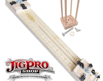May include: A wooden jig for making paracord bracelets. The jig has a ruler on one side and a clamping mechanism on the other. The jig is made of light wood and has a natural finish. The jig is also accompanied by a small wooden stand with dowels and a metal bolt and nut.
