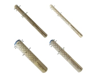 May include: Four wooden Easy Assist Marker tools. Each tool has a light brown woven pattern, metal pins, and a wooden handle. The text "EASY ASSIST MARKER" is printed on the side of each tool.